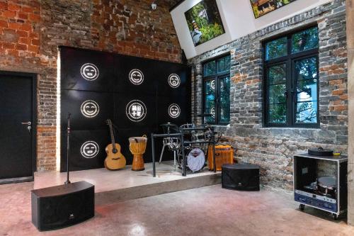 a room with guitars and equipment on a brick wall at Chongqing Desti Youth Park Hostel Liberation Monument in Chongqing