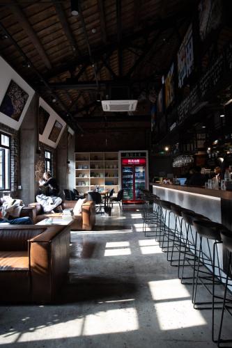 a large room with couches and tables in a building at Chongqing Desti Youth Park Hostel Liberation Monument in Chongqing