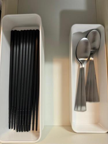 a white container with a spoon and a fork at 五所川原市街好立地 GreatLocation in Goshogawara