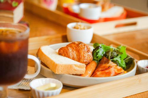 a plate of food with a sandwich and a salad at The GrandWest Arashiyama in Kyoto