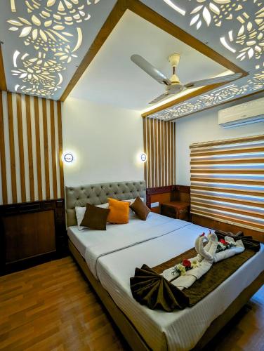 a bedroom with a bed with towels on it at Grand Villa Houseboat in Kumarakom