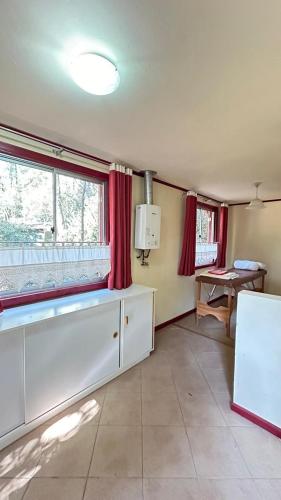 a living room with a large window and a table at Cabañas La Leona in Vilches