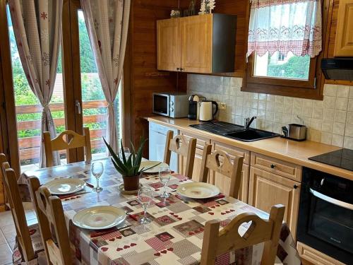 une cuisine avec une table et des chaises dans l'établissement Appartement cosy avec parking et terrasse à Gérardmer - FR-1-589-653, à Gérardmer