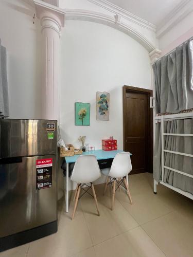 a kitchen with a refrigerator and a table and chairs at LushStay Private Dorm - Near Train Station - Free Water & Laundry in Hanoi
