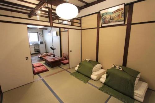 a room with two couches and a living room at Sunrise House 桃谷 in Osaka