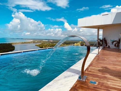 a swimming pool with a water fountain at Paiva Flats By Loui 2 in Recife