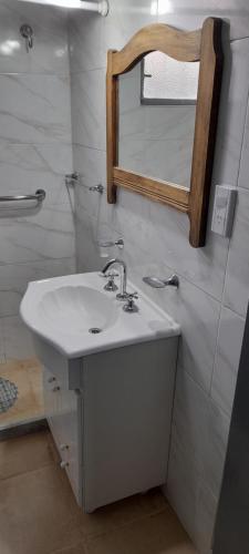 a bathroom with a sink and a mirror at Sierras in La Falda