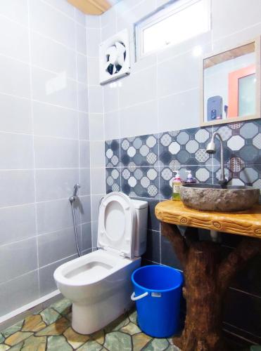 a bathroom with a toilet and a sink at Nulu View Cabin in Kundasang