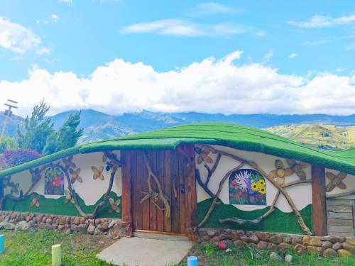 a painting of a house with a green roof at Nulu View Cabin in Kundasang