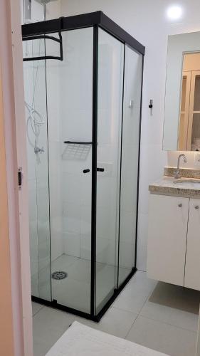 a glass shower in a bathroom with a sink at Blend Coliving One - 1 in Ribeirão Preto