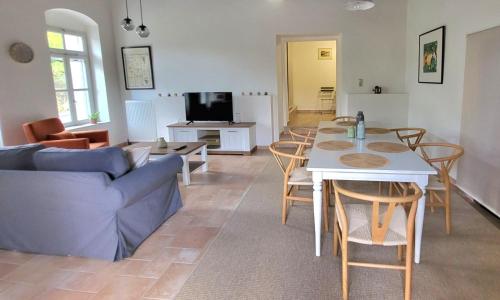 a living room with a couch and a table and chairs at Portokalia in Mystras