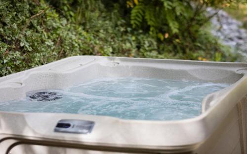 a hot tub filled with blue water in astrationsenalsenalsenalsenalsenalsenal at Bear Clubhouse in Pigeon Forge