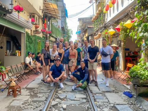 a group of people posing for a picture on a street at Old Quarter View Hanoi Hostel in Hanoi