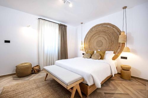 a bedroom with a large bed with a large headboard at Rastoni Villas in Psalidi