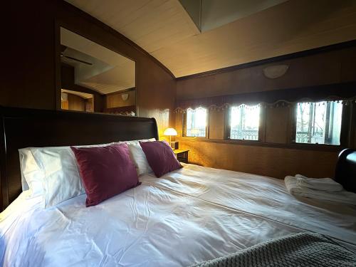 a bedroom with a large bed with a purple pillow at Heaven in the Hills Retreat in Maleny