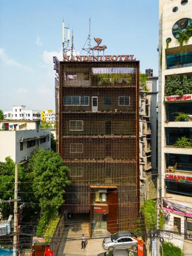 a tall building with a sign on top of it at Hotel Nandini in Dhaka