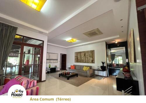 a living room with a couch and a table at Rey House in Satuba