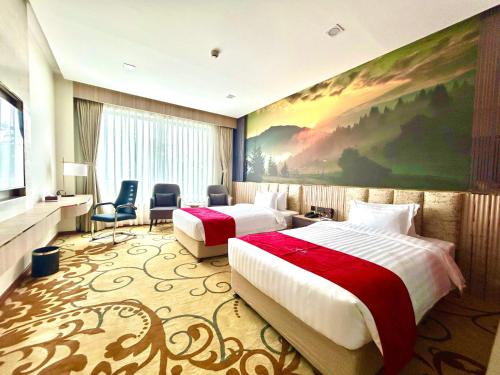 a hotel room with two beds and a painting on the wall at Hotel Mechi Crown in Kakarvitta