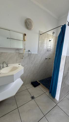 a bathroom with a sink and a shower at Accom KC's in Airlie Beach