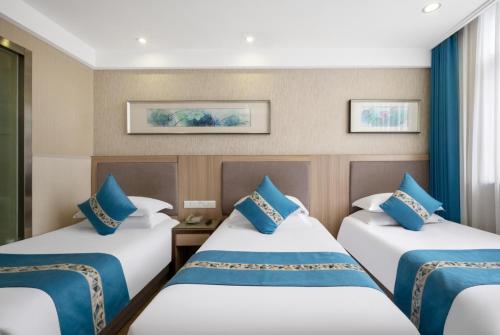 Postel nebo postele na pokoji v ubytování 义乌商洲宾馆国际商贸城店Yiwu Shangzhou Hotel - International Trade City