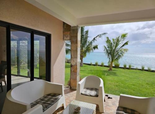 a living room with a view of the ocean at Villas Vetiver in Rodrigues Island