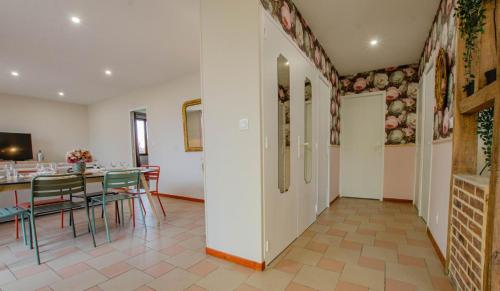 a dining room with a table and chairs at La petite maison dans lusigny in Lusigny-sur-Barse