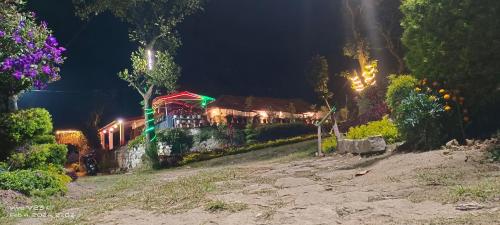 a house lit up at night with lights at Munnar home stay in Munnar