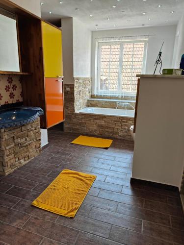 a bathroom with a bath tub and a yellow towel at Ferienwohnung Dorfleben, nahe Jennersdorf und Therme in Windisch Minihof