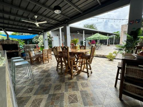 a patio with a wooden table and chairs at Villa Tungara in Bejuco