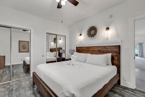 a bedroom with a large white bed and a mirror at Elegant 3BR Condo - Magnolia North 101 in Myrtle Beach