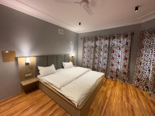 a bedroom with a large bed and a window at Silk Route in Srinagar