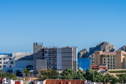 a city with a mountain in the background at Apartment with Private Rooftop in Medano in Cabo San Lucas