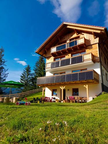 a house with solar panels on the side of it at Chalet Leni in Schladming