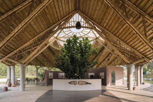 a large building with a large tree in the middle at ORO The Estates, Nandi Hills in Nandigunda