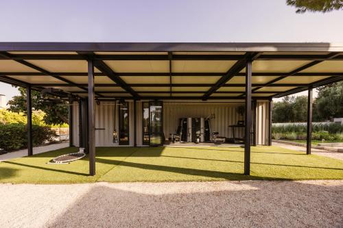 a large metal pavilion with grass in a yard at Cook's Club Ialysos Rhodes in Ialyssos
