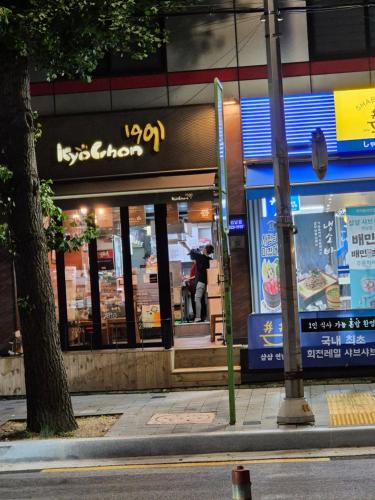 a person standing in front of a store at Sophie House foreigners women only in Seoul