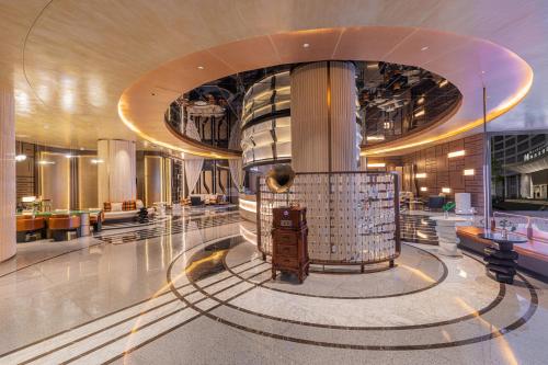a lobby of a building with a large building at Shanghai Maybeours Hotel in Fengxian
