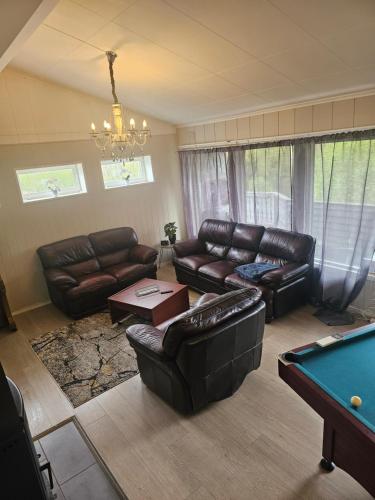 a living room with couches and a pool table at Rooms in Montana Guest house in Lillestrøm
