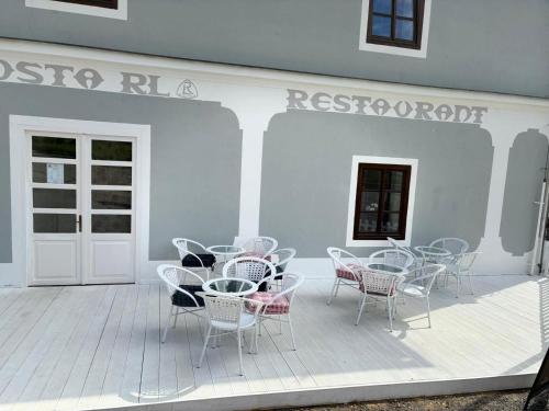 a group of chairs and tables on a patio at Boutique Hotel Pošta RL in Oravský Podzámok