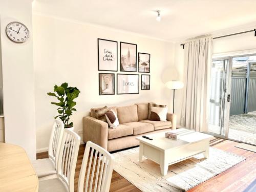 a living room with a couch and a table at Heartwarming 3BR-Townhouse in Broadview