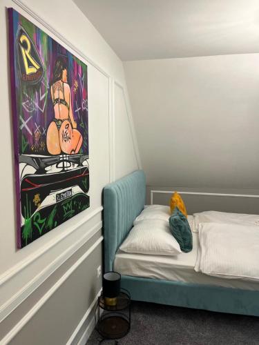 a room with a bed and a painting on the wall at Boutique Hotel Pošta RL in Oravský Podzámok