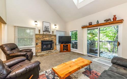 a living room with leather furniture and a fireplace at Mountain Bliss in Gatlinburg