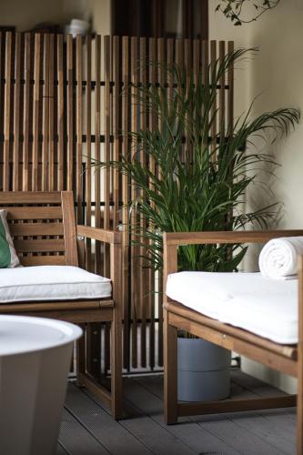 a room with two chairs and a plant at PENTHOUSE CON VISTA [6 minuti dal Bernina Express] in Tirano