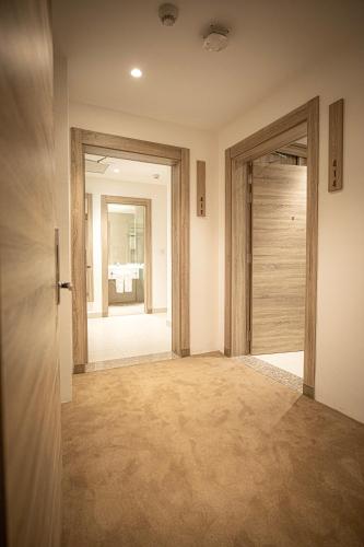 an empty hallway with a door and a room with at Golden Tulip Amman in Amman