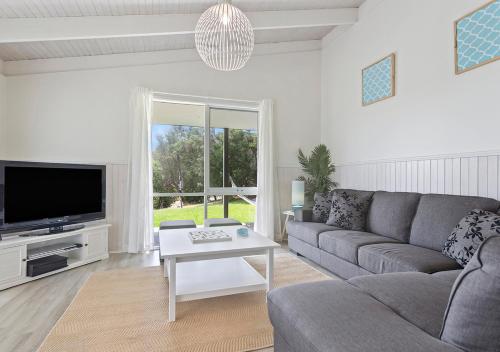 a living room with a couch and a tv at Seaesta Rye by Ready Set Stay - BYO LINEN & TOWELS in Rye