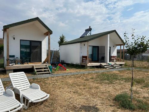 a small house with a man on top of it at Summer Home Corbu in Corbu
