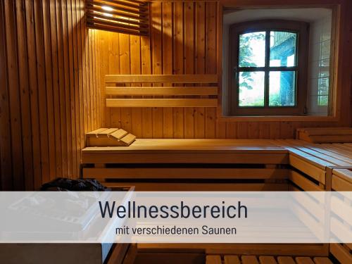 a room with a sauna with a window at Gut Weihersmühle in Leutershausen