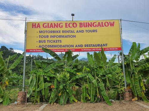 a sign in front of a bunch of banana plants at Ha Giang Eco Bungalow in Ha Giang