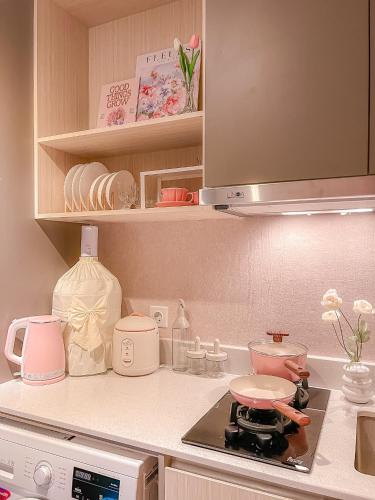 a kitchen with a stove and a counter top at Gold Coast PIK Apartments by Host Jess in Jakarta