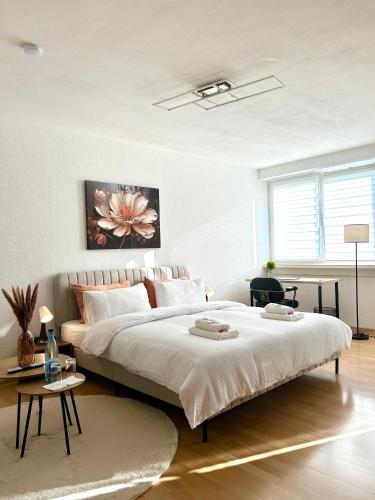 a bedroom with a large bed and a table at Wohnung in Monheim am Rhein in Monheim